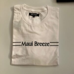 Folded white T-shirt with "Maui Breeze" logo